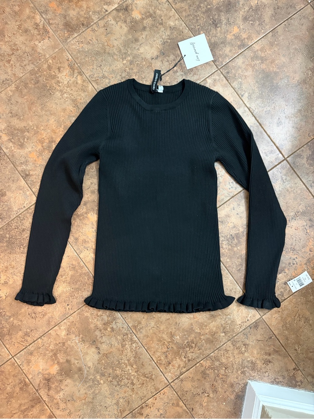 Ribbed Crewneck Sweater with Ruffle Hem in Black